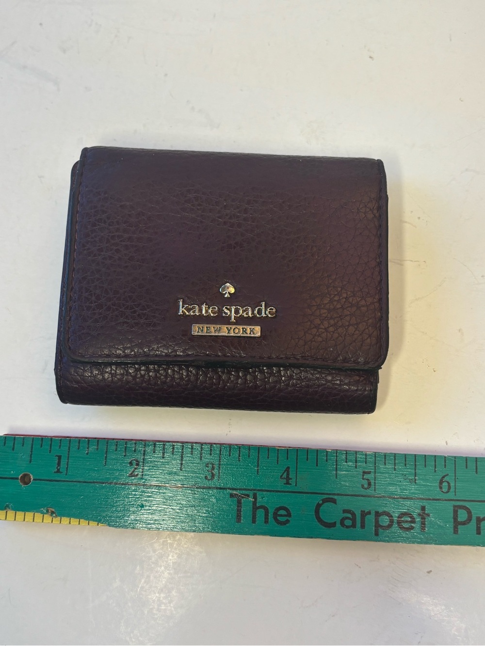 kate spade plum pebbled leather trifold wallet with gold logo